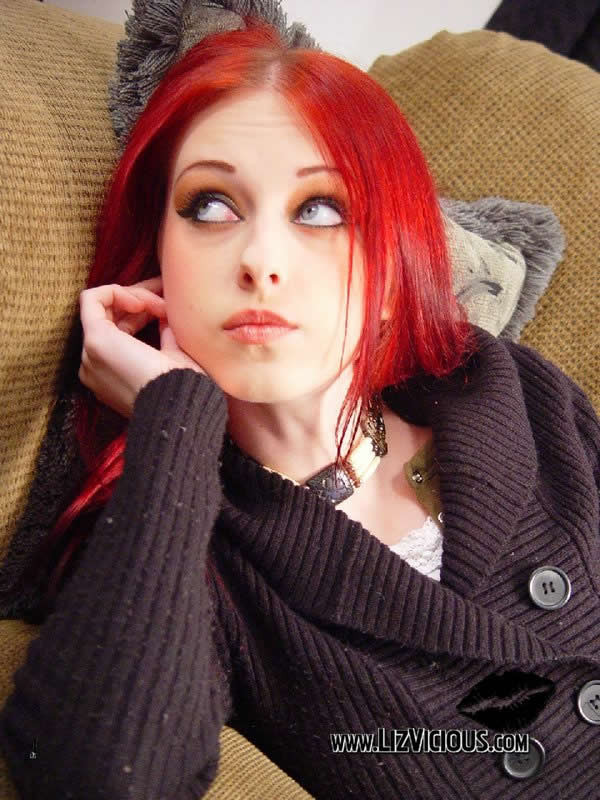 Redhead Goth Chick Liz Vicious Posing On The Couch