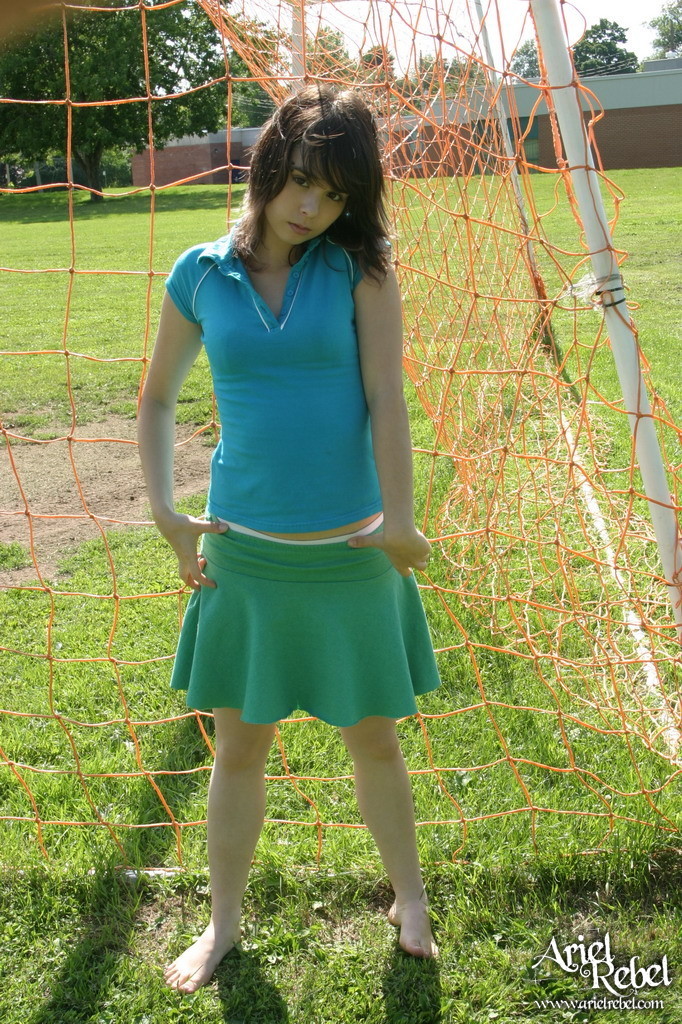 Sporty teen girl in skirt outside