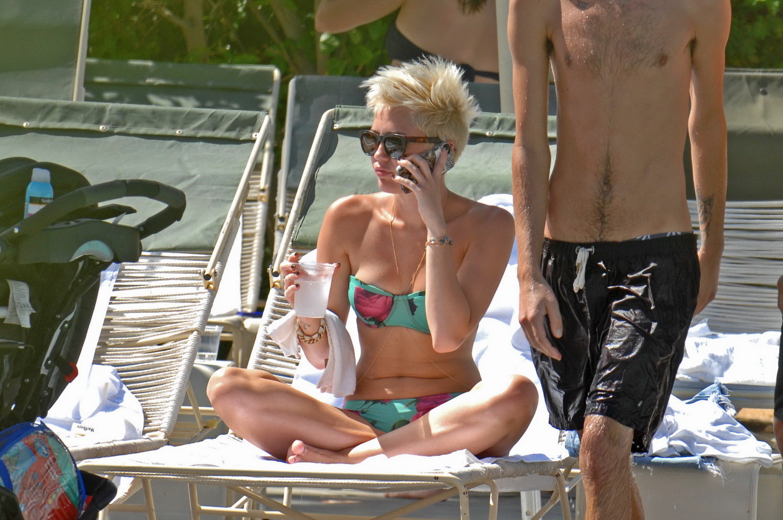 Miley cyrus luciendo un bikini de tubo floral junto a la piscina en el hotel palm desert en palm spr
 #75238576