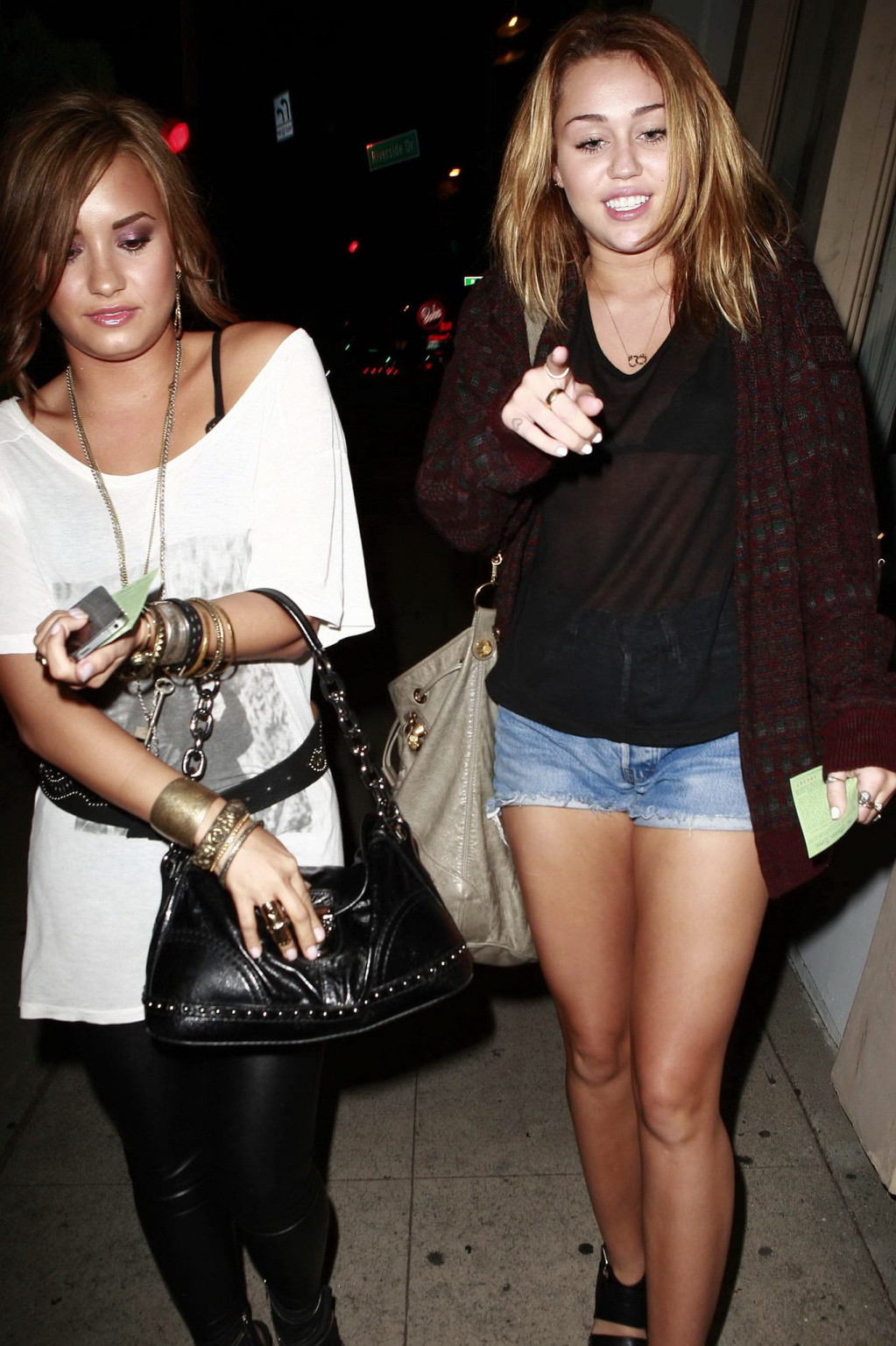 Miley Cyrus wearing denim shorts  black bra under see-through top in LA #75332907