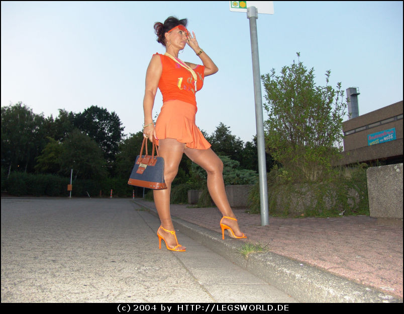 日焼けしたストッキングで脚の長いドイツ人女性が公衆の面前でポーズをとる
 #78035064