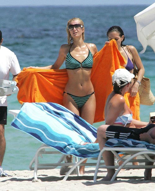 Paris Hilton in green bikini on beach paparazzi pictures #75441724