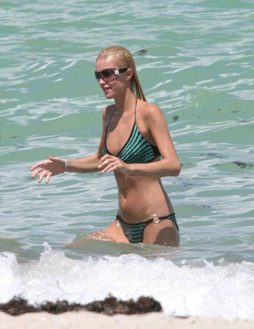 Paris Hilton in green bikini on beach paparazzi pictures #75441829