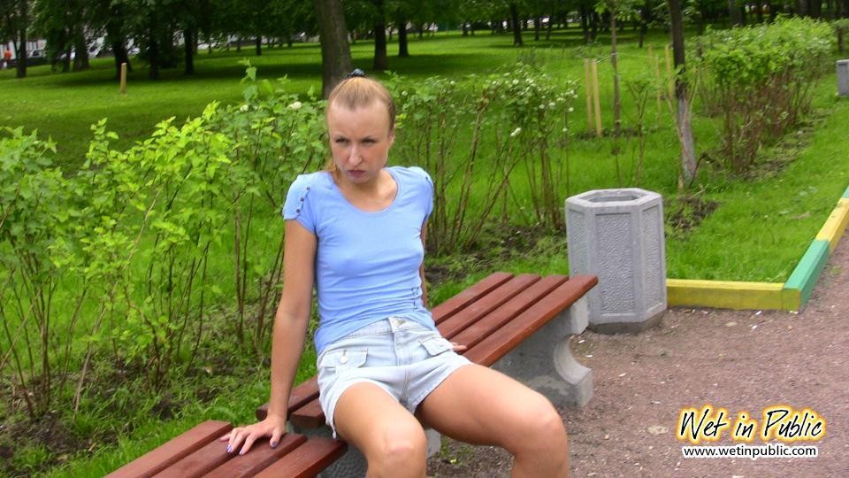 Cutie in shorts unleashes her pissing urge spreading in a public park #73238954