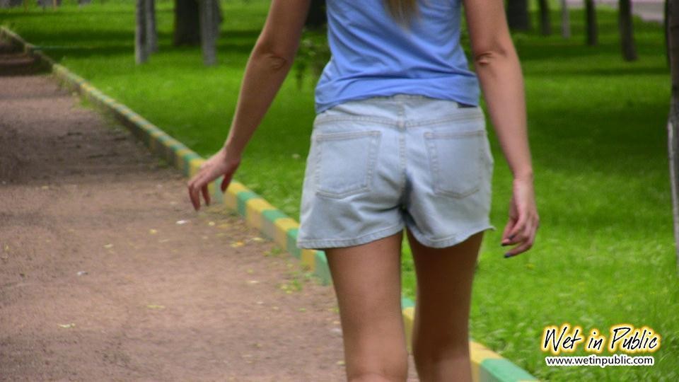 Cutie in shorts unleashes her pissing urge spreading in a public park #73238996