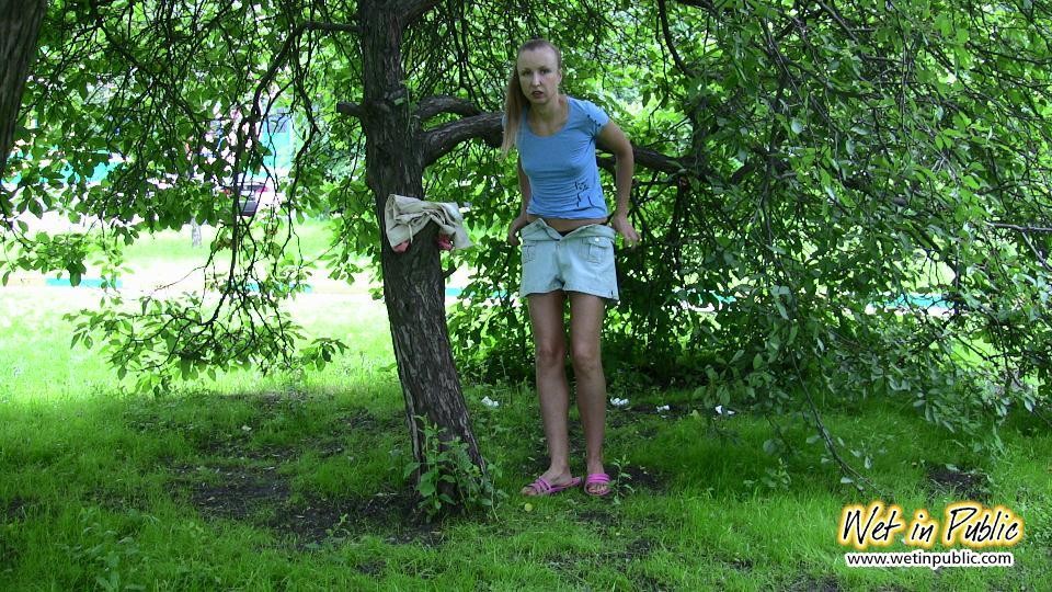 Cutie in shorts unleashes her pissing urge spreading in a public park #73239004