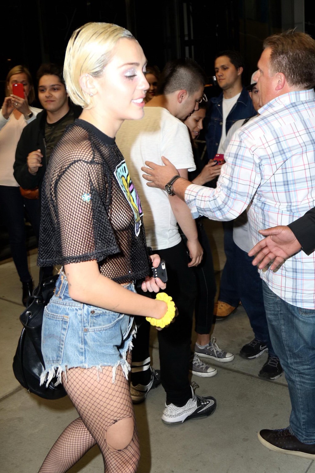 Miley Cyrus shows off her boobs wearing a mesh Tshirt out in NYC #75164209