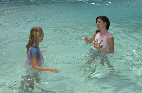 Cute lesbian in a swimming pool #74103696