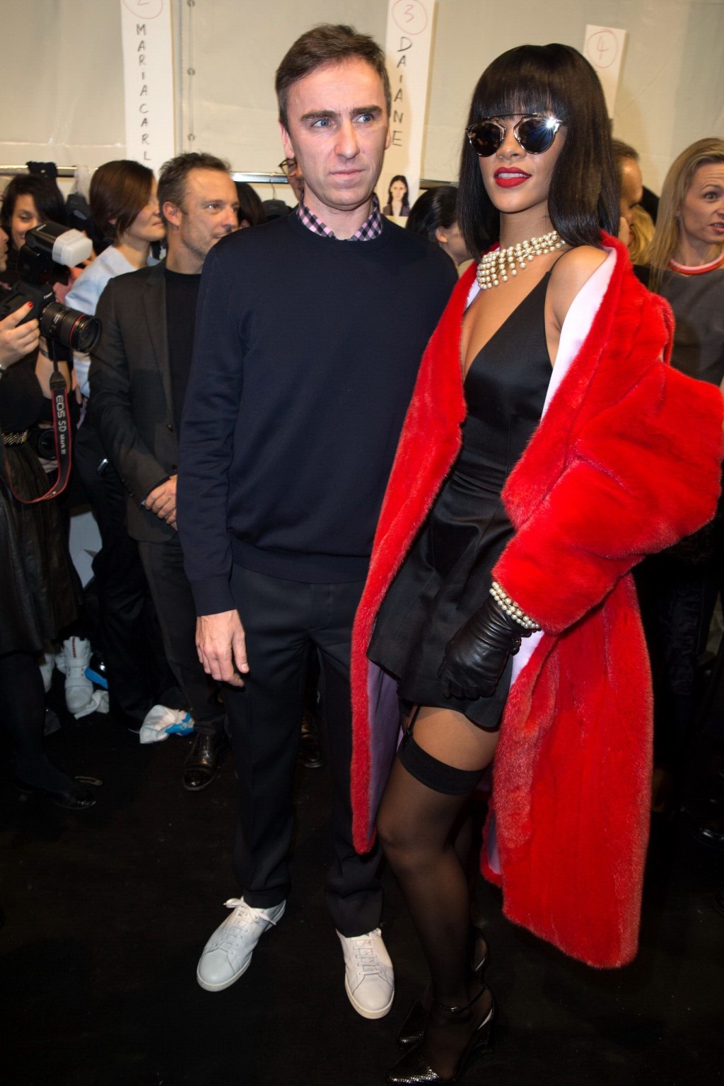 Rihanna showing off her stockings and cleavage at the Christian Dior fashion sho #75203620