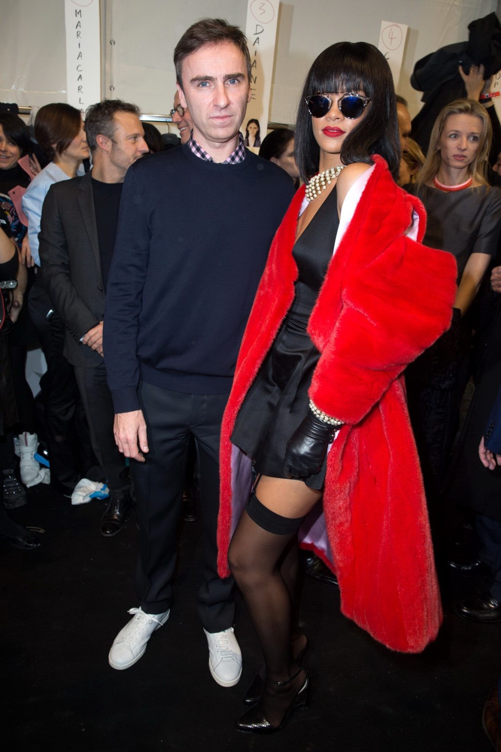 Rihanna showing off her stockings and cleavage at the Christian Dior fashion sho #75203633