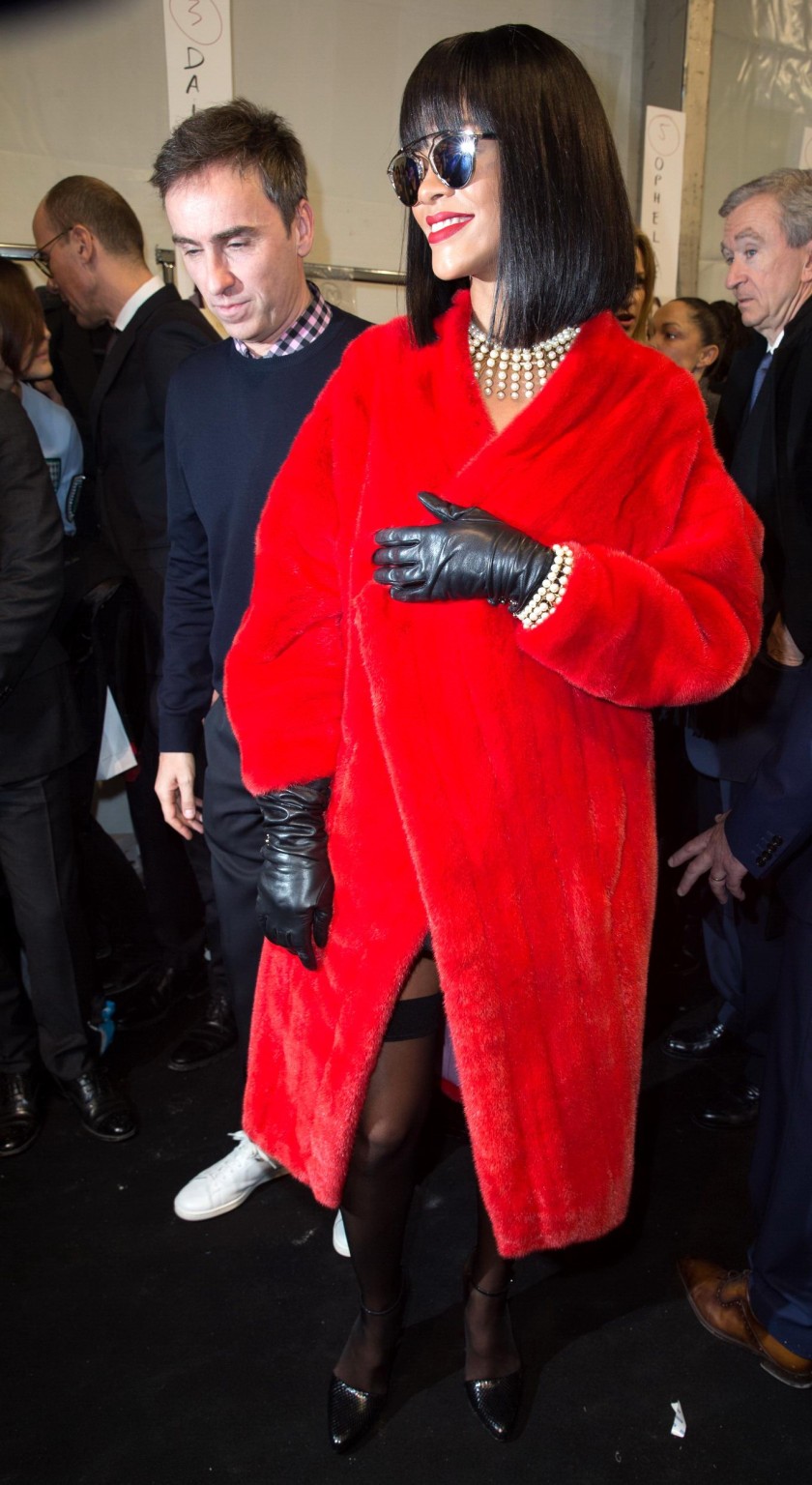 Rihanna showing off her stockings and cleavage at the Christian Dior fashion sho #75203657