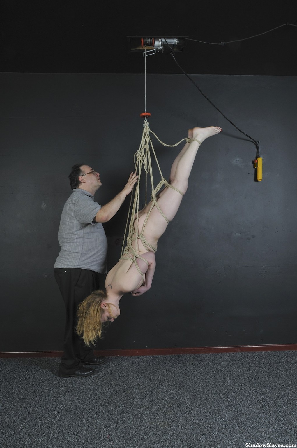 Amber West is tied up tightly and then hoisted up to the ceiling #67343611