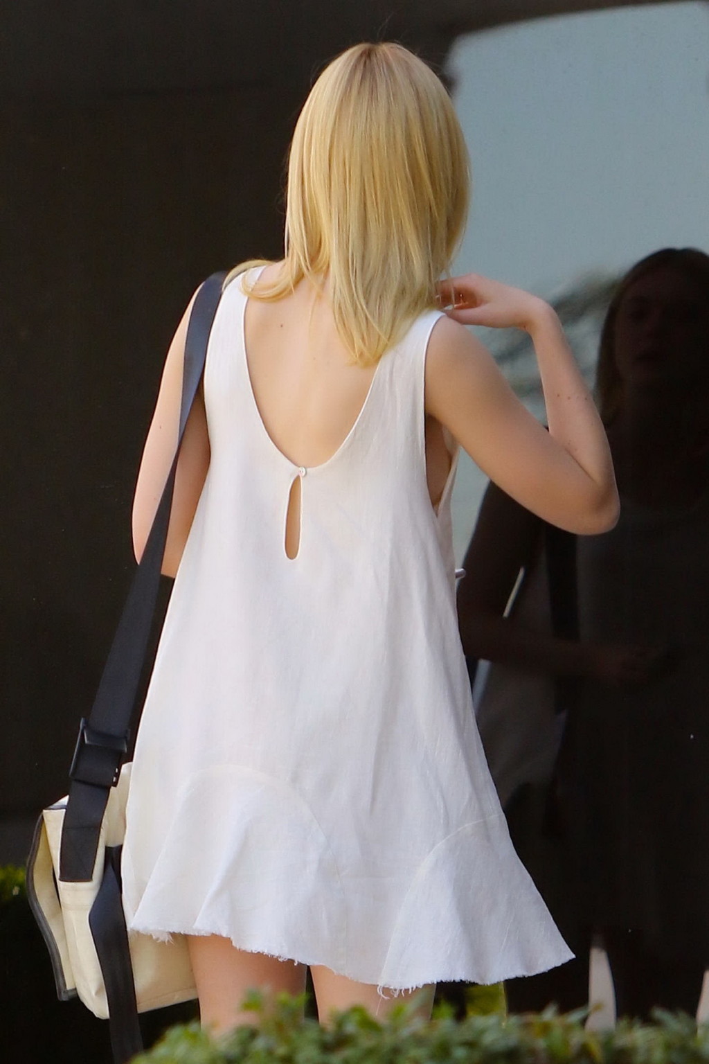 Elle Fanning shows off her bare boob in white mini costume