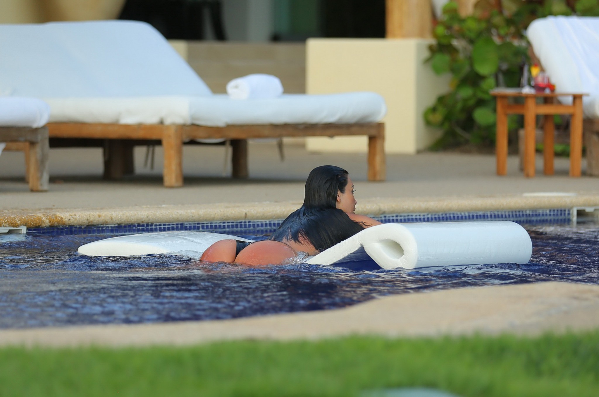 Kim Kardashian shows off her curvy body in a skimpy black bikini at the pool in  #75193607