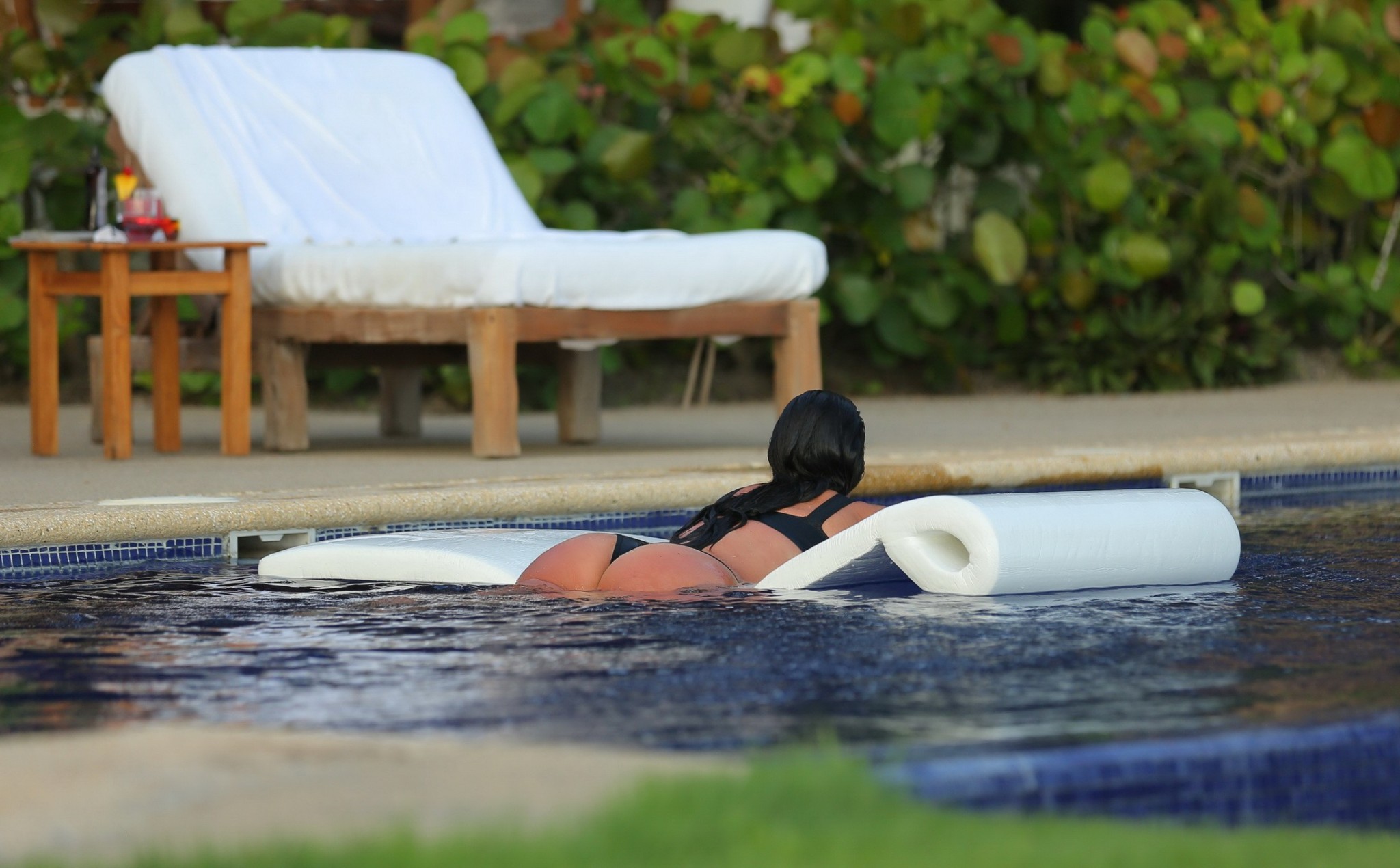 Kim Kardashian shows off her curvy body in a skimpy black bikini at the pool in  #75193619