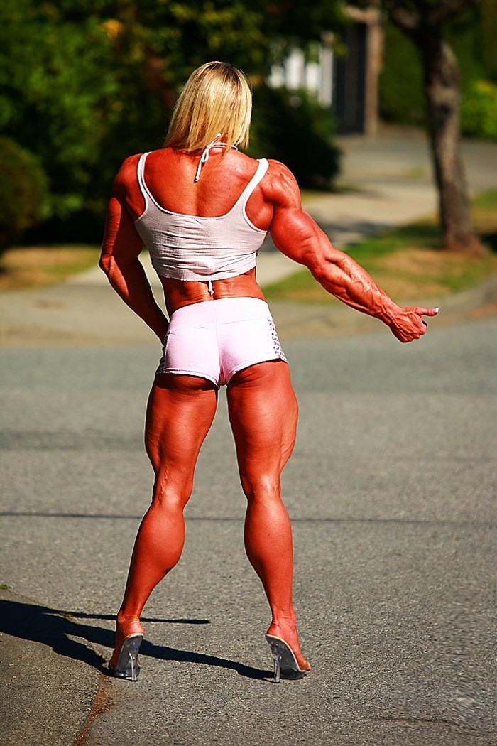 Massive ripped muscular woman posing outdoors #71543874