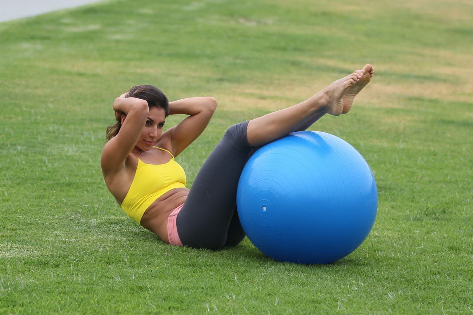 Leilani Dowding practicing yoga in a sports bra and leggings at the park in LA #75201895