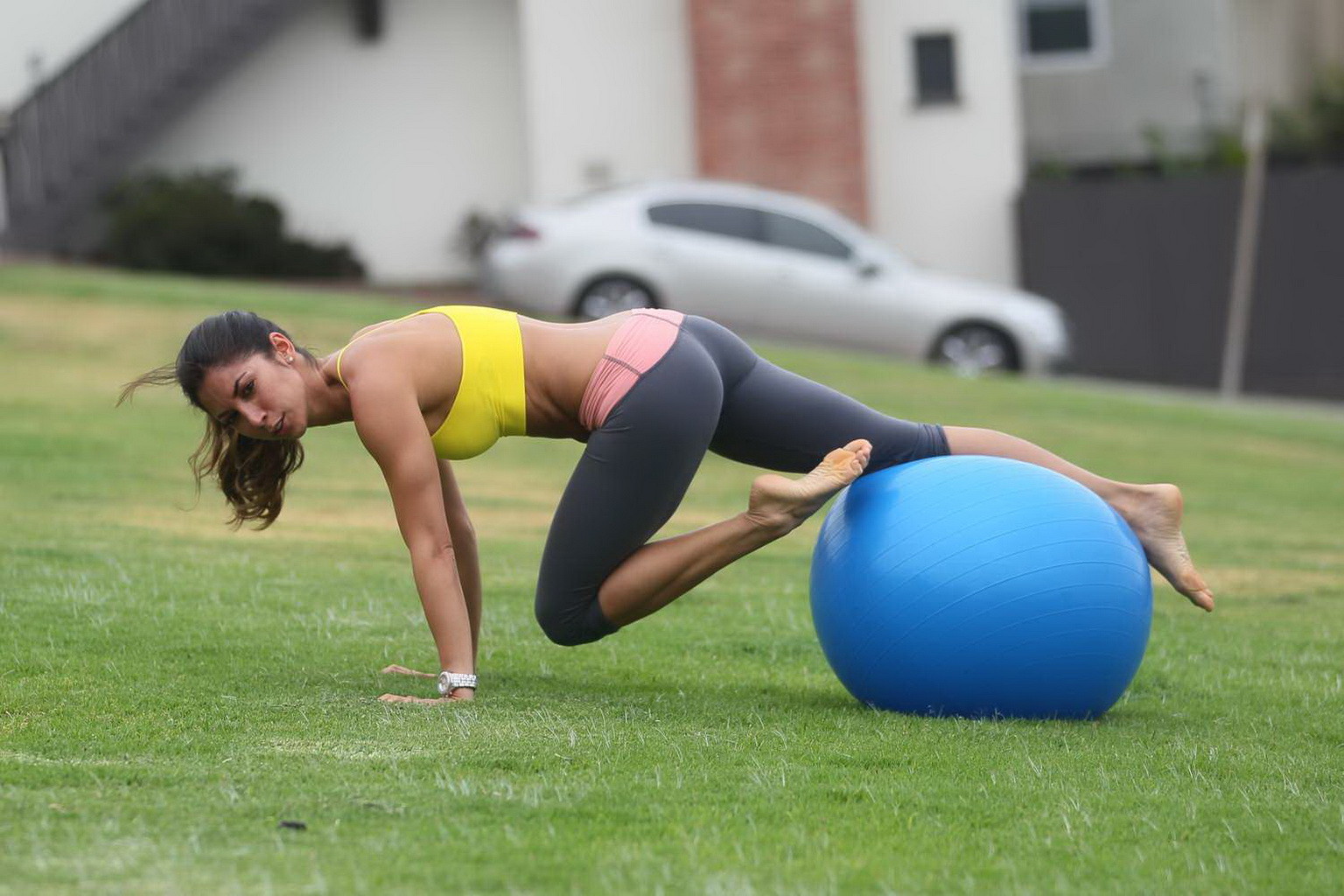 Leilani Dowding practicing yoga in a sports bra and leggings at the park in LA #75201921