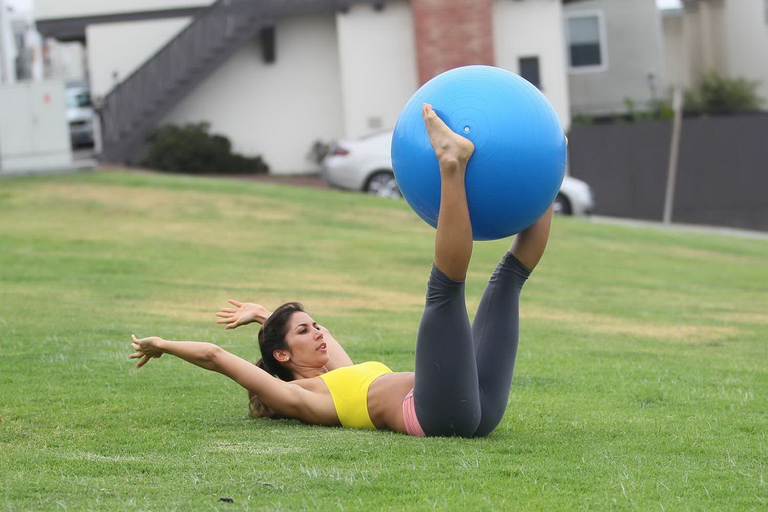 Leilani Dowding practicing yoga in a sports bra and leggings at the park in LA #75201950