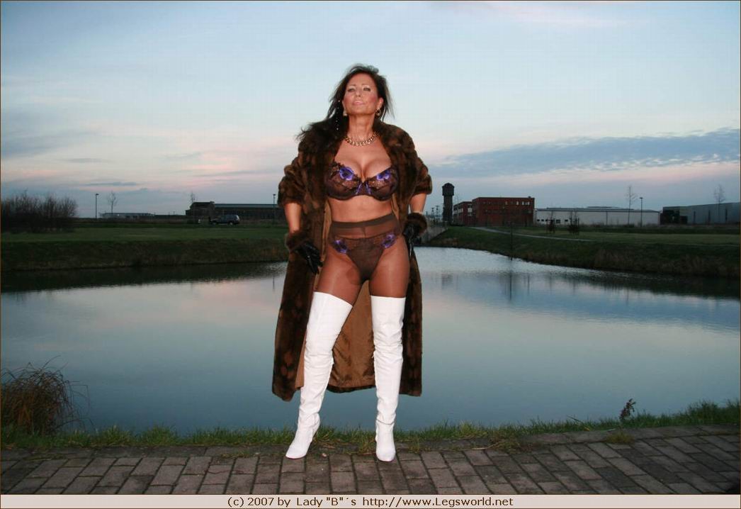 Leggy pantyhose lady in boots posing outdoors #78031835