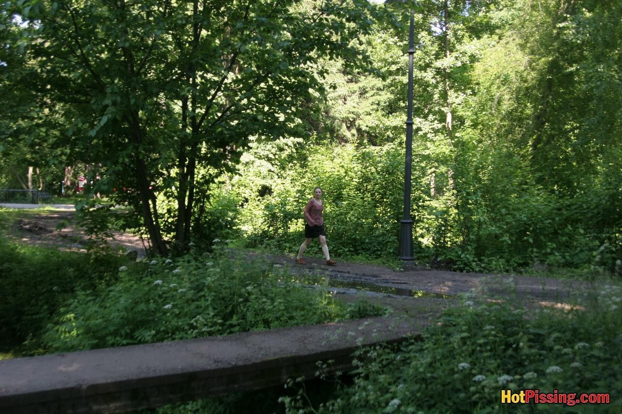 Blushing chick in glasses does a great pee stream from the park bridge #76521229