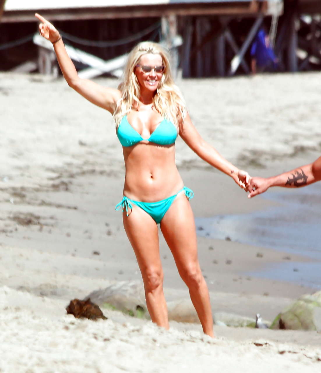 Jenny McCarthy looking very cute and sexy in green bikini on beach #75288637