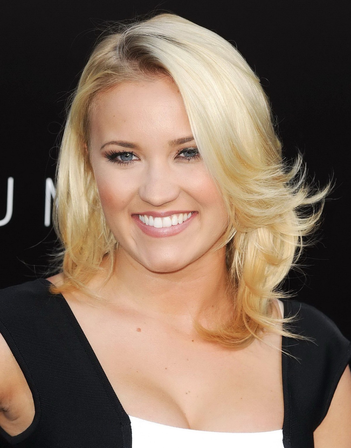 Emily Osment showing cleavage at the 'Elysium' premiere in Westwood #75222391