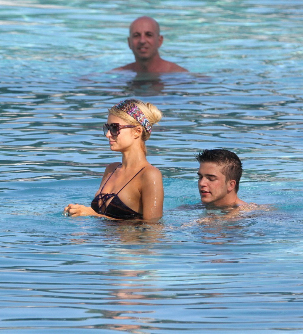 Paris Hilton showing off her hot body in skimpy multi colored swimsuit at a pool #75246581