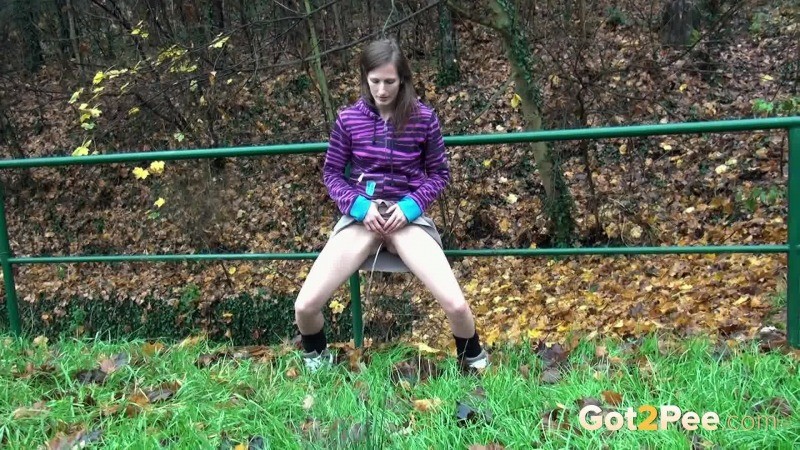 Brunette pisses while standing up next to a road #67488906