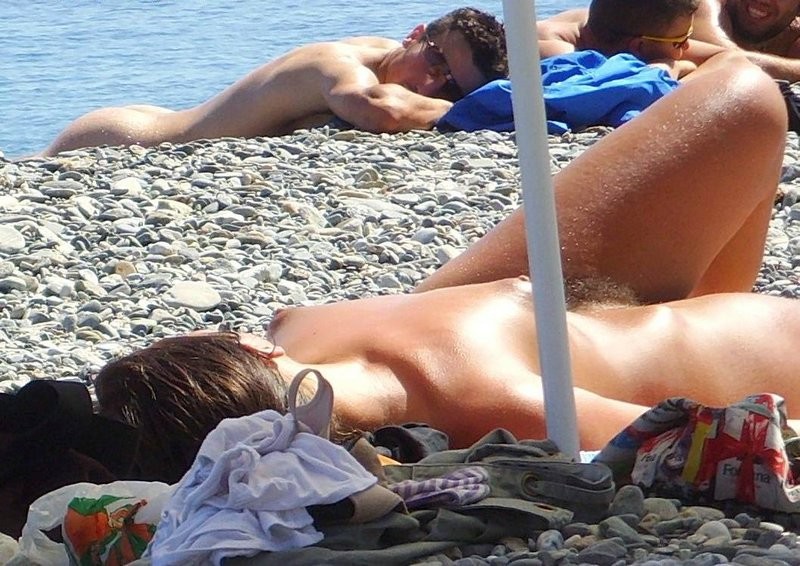 All eyes are on this young nudist as she sunbathes #72253397