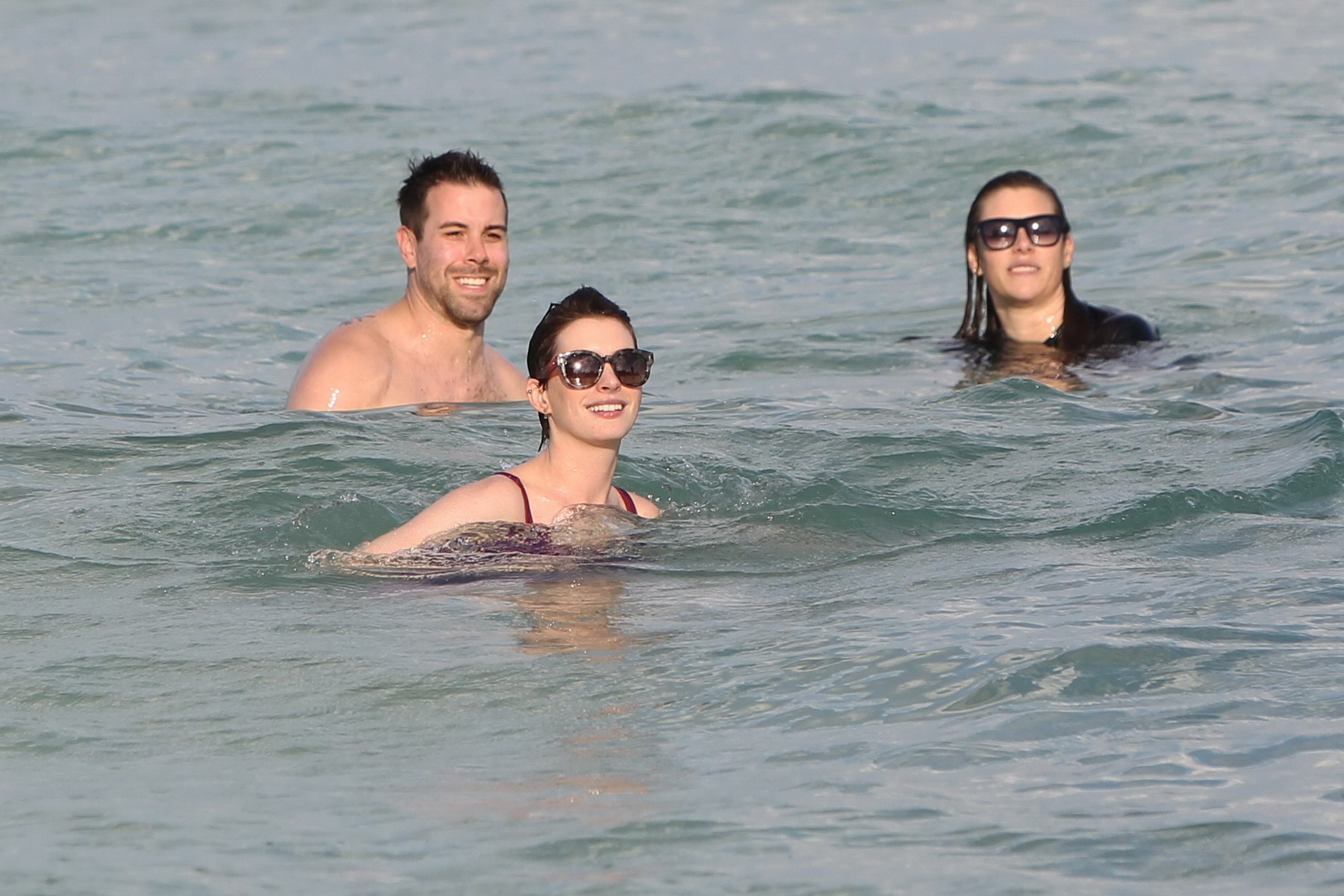 Anne Hathaway wearing wet purple see-through swimsuit and shorts at the beach in #75200940
