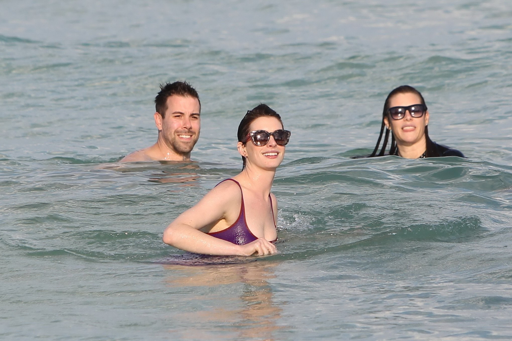 Anne Hathaway wearing wet purple see-through swimsuit and shorts at the beach in #75200948