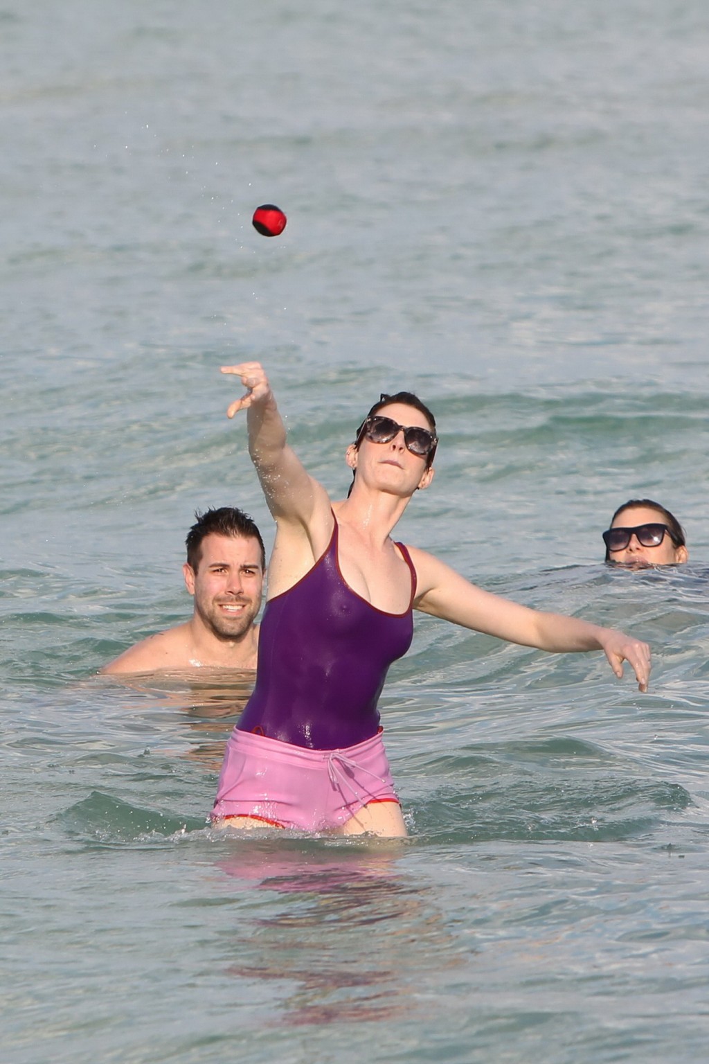 Anne Hathaway wearing wet purple see-through swimsuit and shorts at the beach in #75200981
