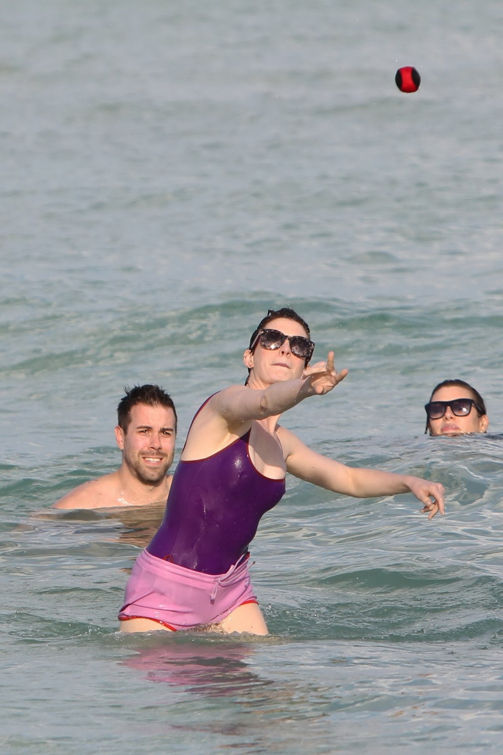 Anne Hathaway wearing wet purple see-through swimsuit and shorts at the beach in #75200989