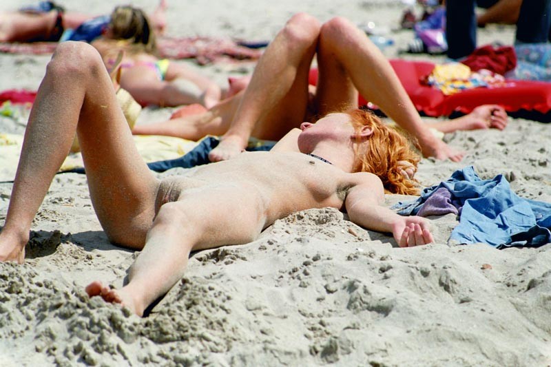 Nudisti caldi fumanti nudi in una spiaggia pubblica
 #72252379