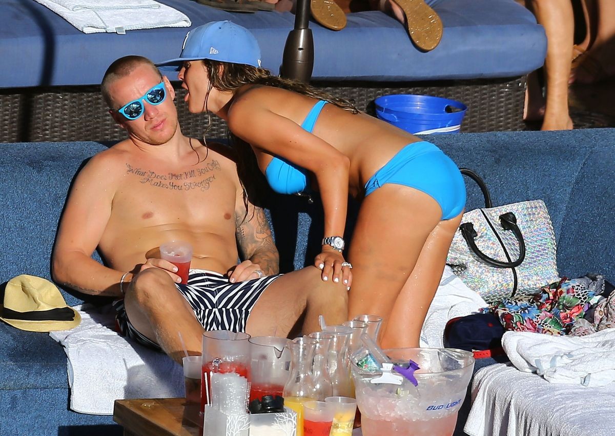Danielle Lloyd shows off her big boobs in a blue tube bikini poolside in Las Veg