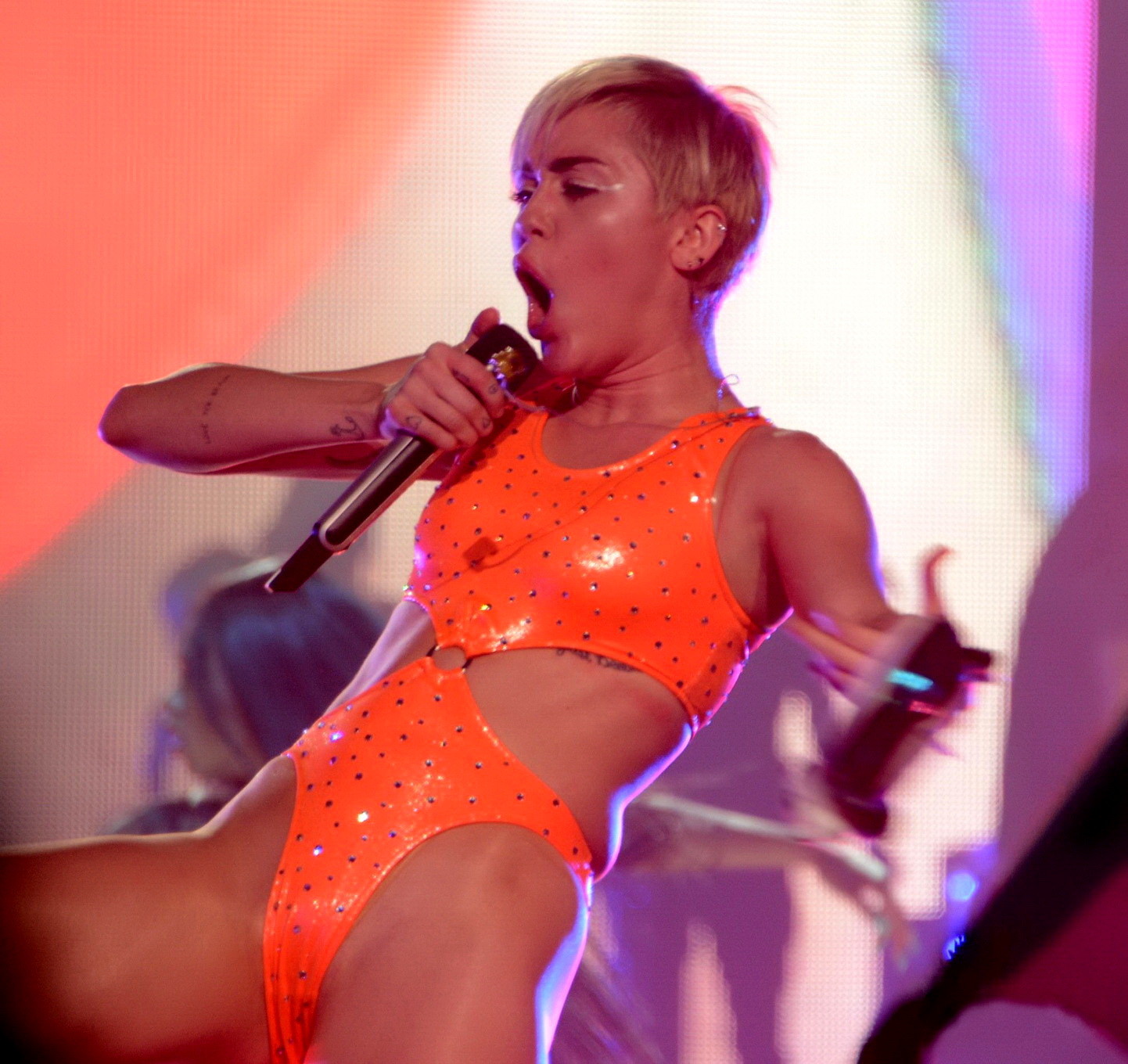 Miley Cyrus in an orange swimsuit performing at Bangerz Tour in San Juan Puerto  #75185787