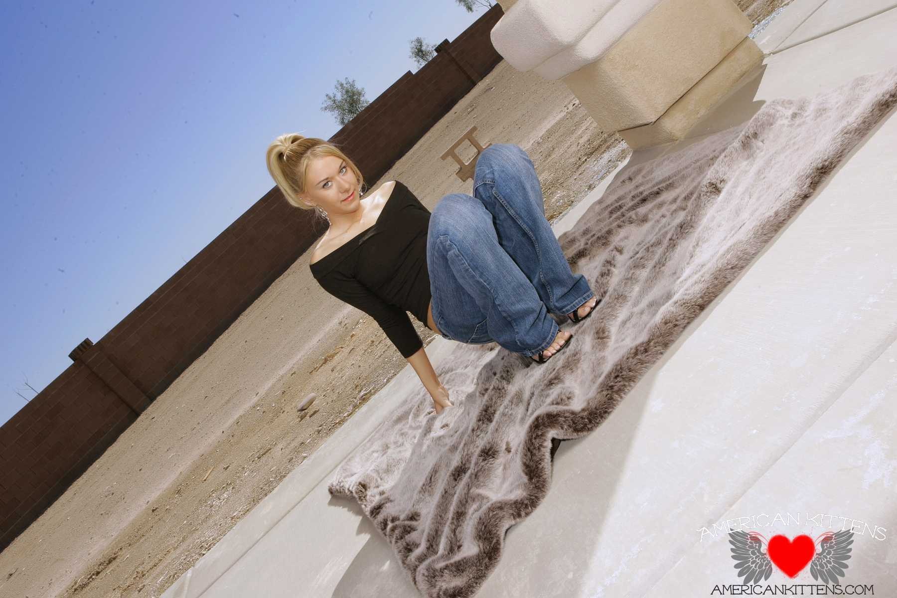 Ashlee is outside wearing some tight jeans and a black top #77156300