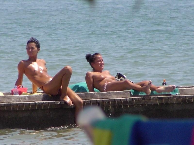 Sexy nackte Teens spielen zusammen an einem öffentlichen Strand
 #72256983