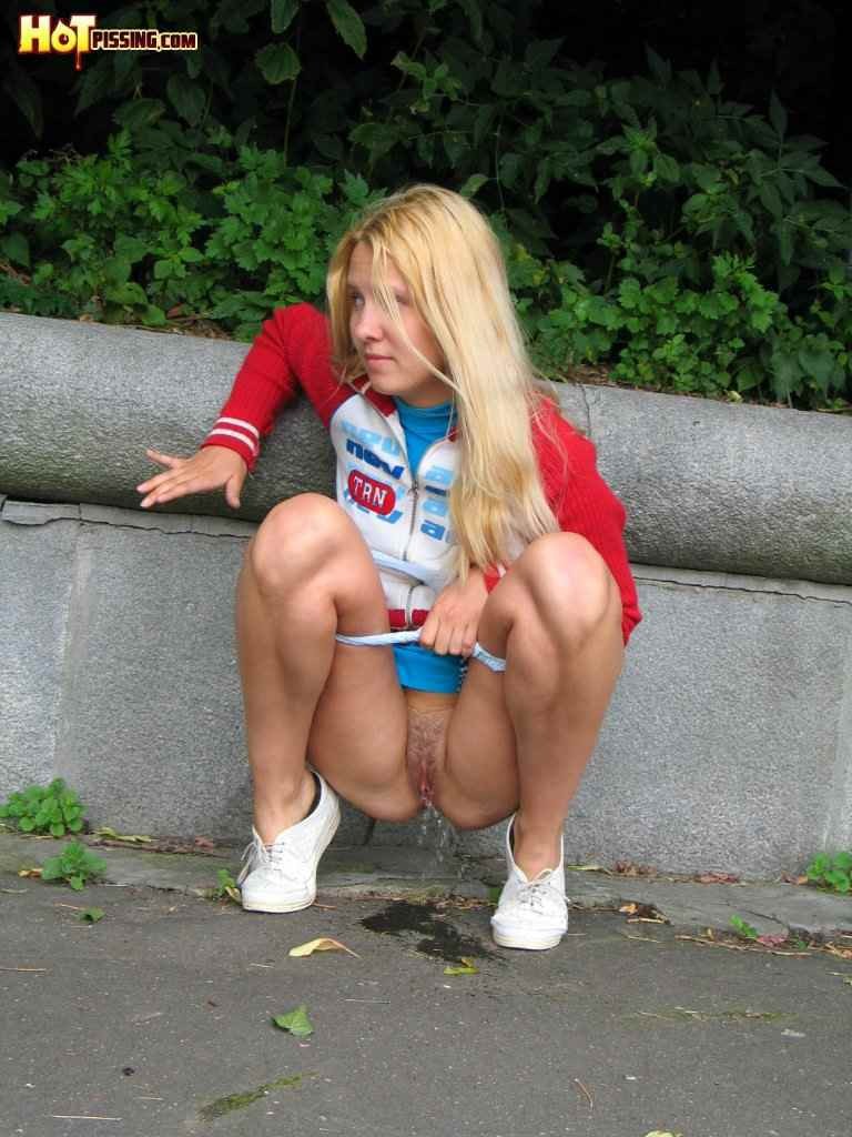 Cute blonde pissing in the street #76586276