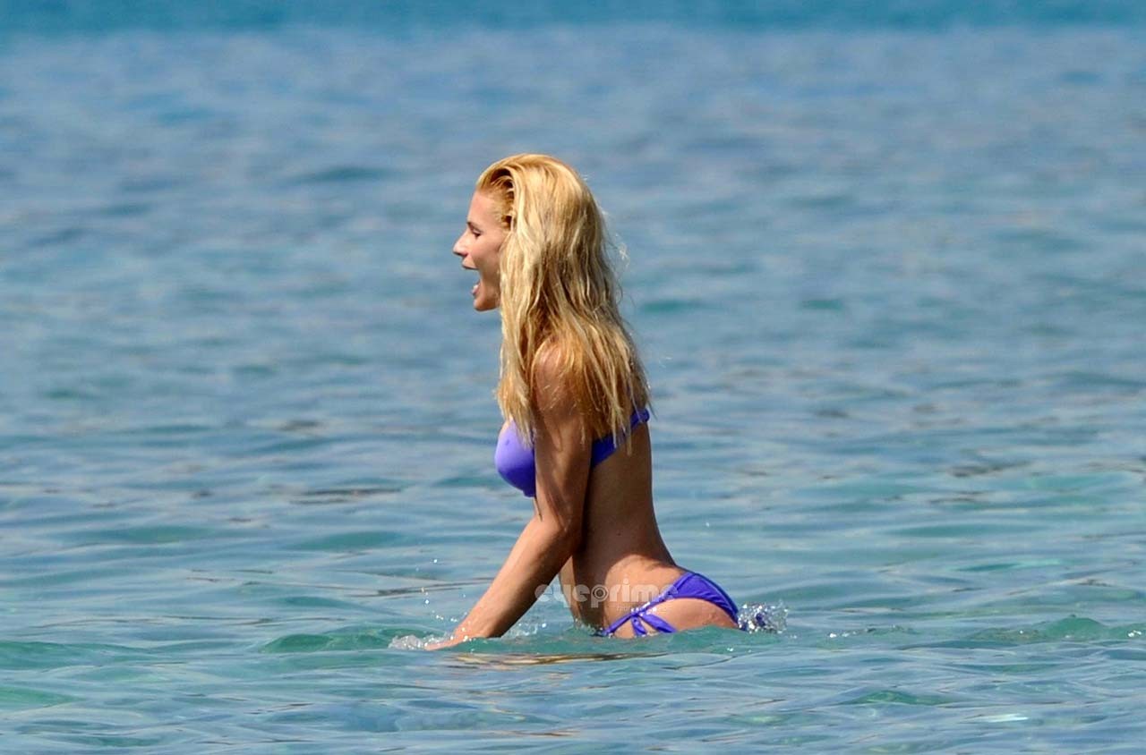 Michelle Hunziker looking very sexy in blue bikini on beach paparazzi pictures #75303680