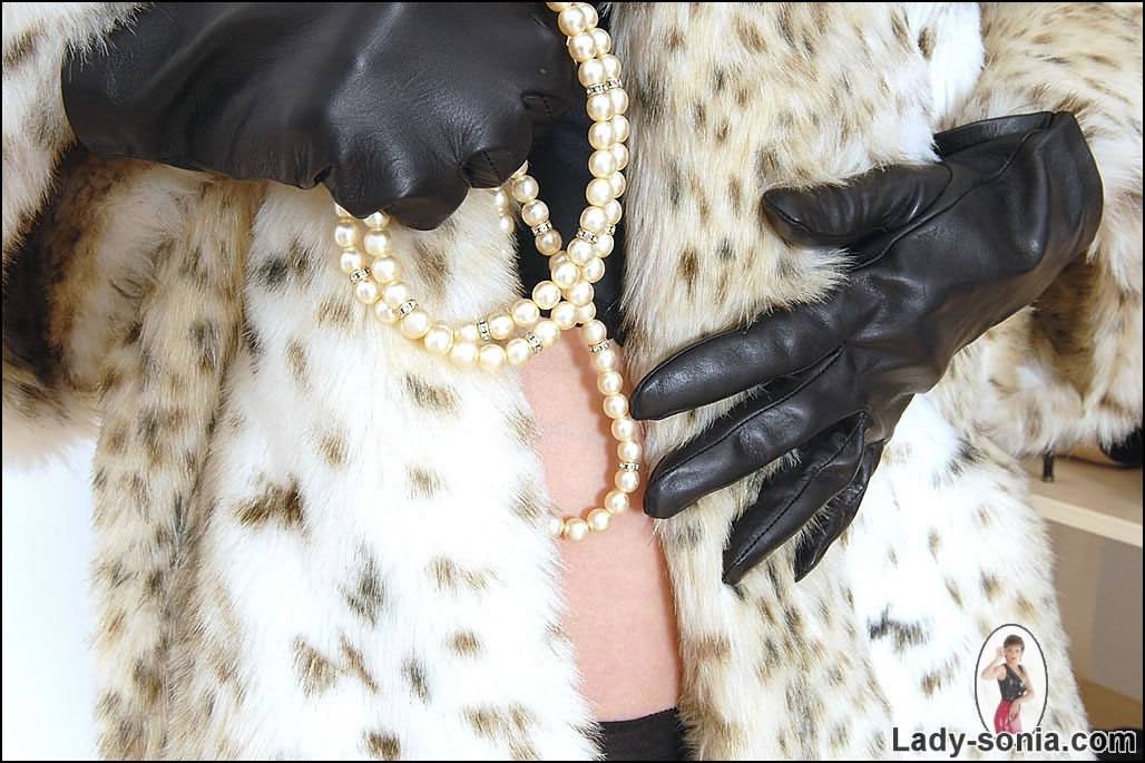 Lady in stockings posing in long fur coat #78028169