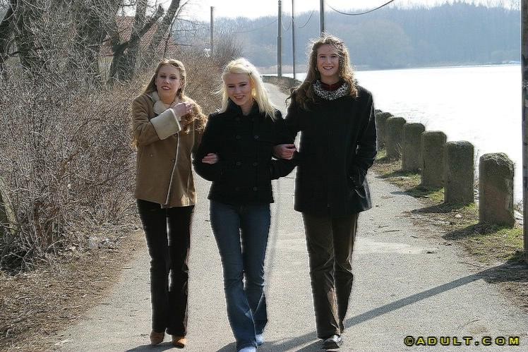 Three cute playful lesbians walking in the park #74037238