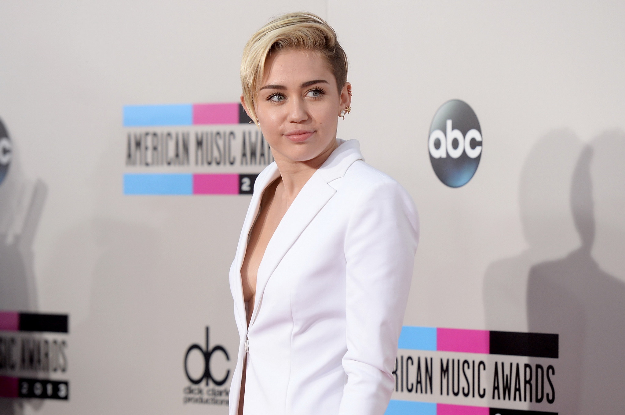 Miley Cyrus braless showing great cleavage in a white suit at 2013 American Musi #75212072