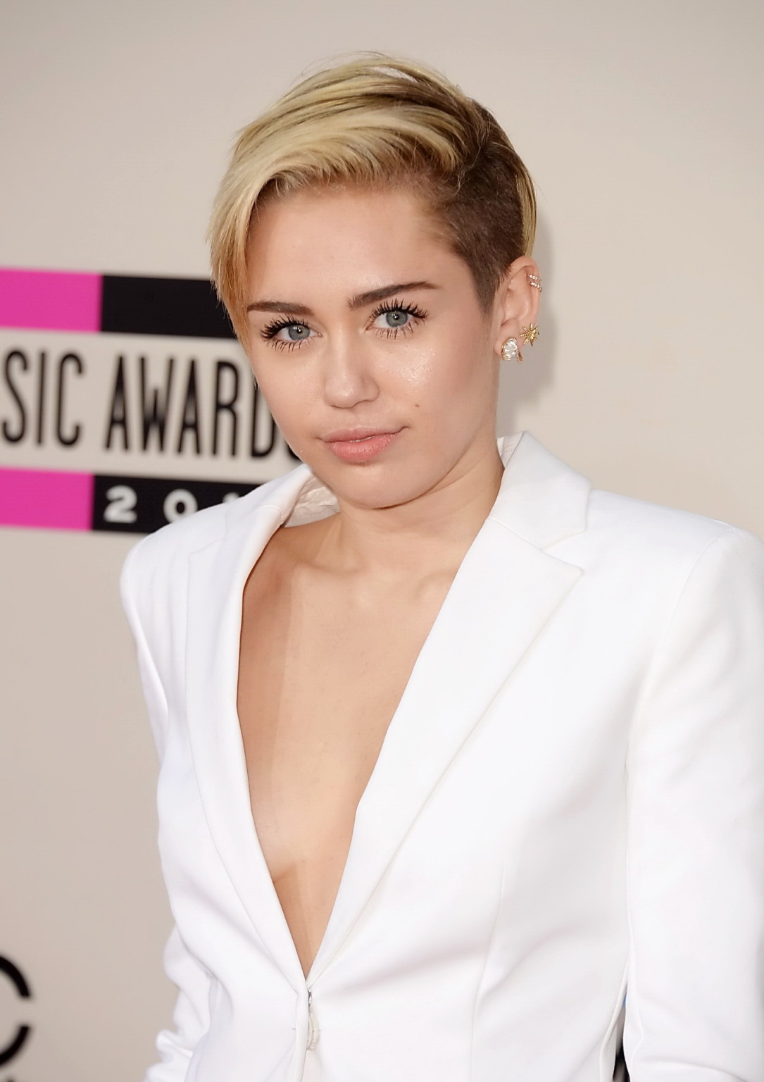 Miley Cyrus braless showing great cleavage in a white suit at 2013 American Musi #75212091