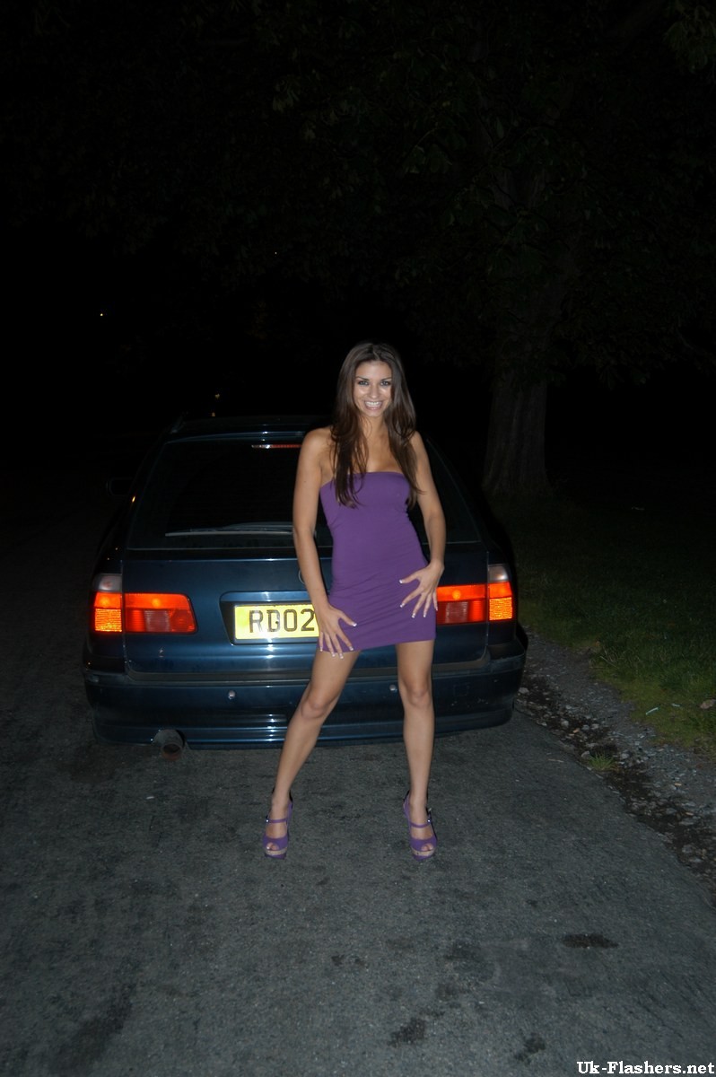 Cute amateur flashing outdoors at night on a car