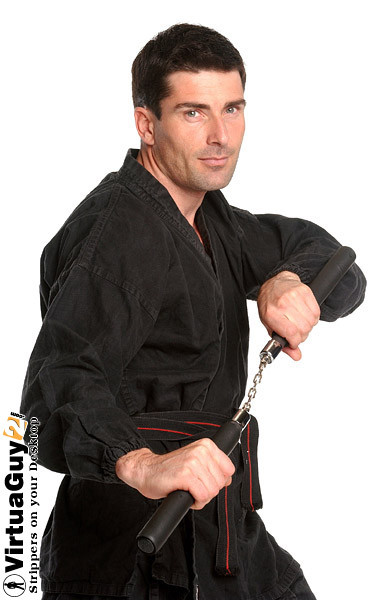 Brunette guy with nunchaku posing #76990667