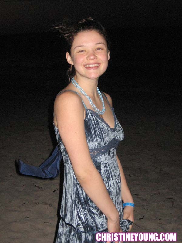 Cheerful teen Christine Young poses after dark on the beach #73118552