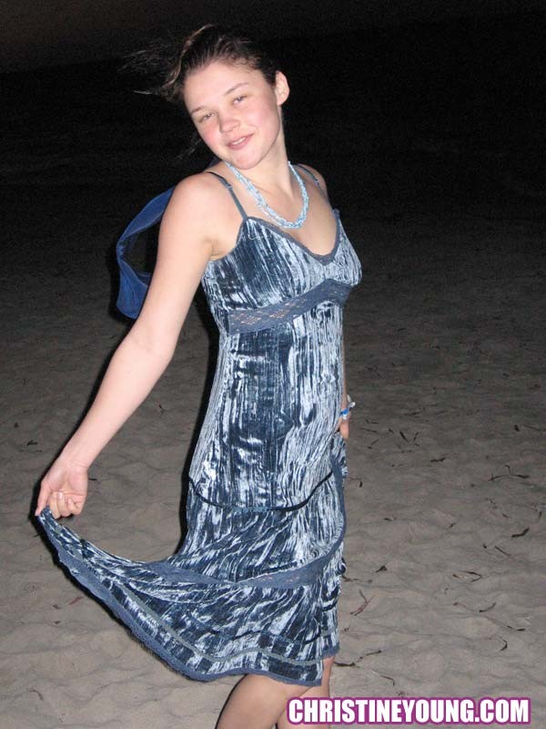 Cheerful teen Christine Young poses after dark on the beach #73118560