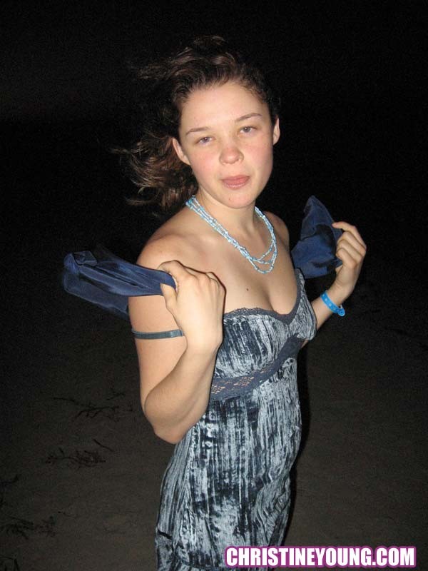 Cheerful teen Christine Young poses after dark on the beach #73118576